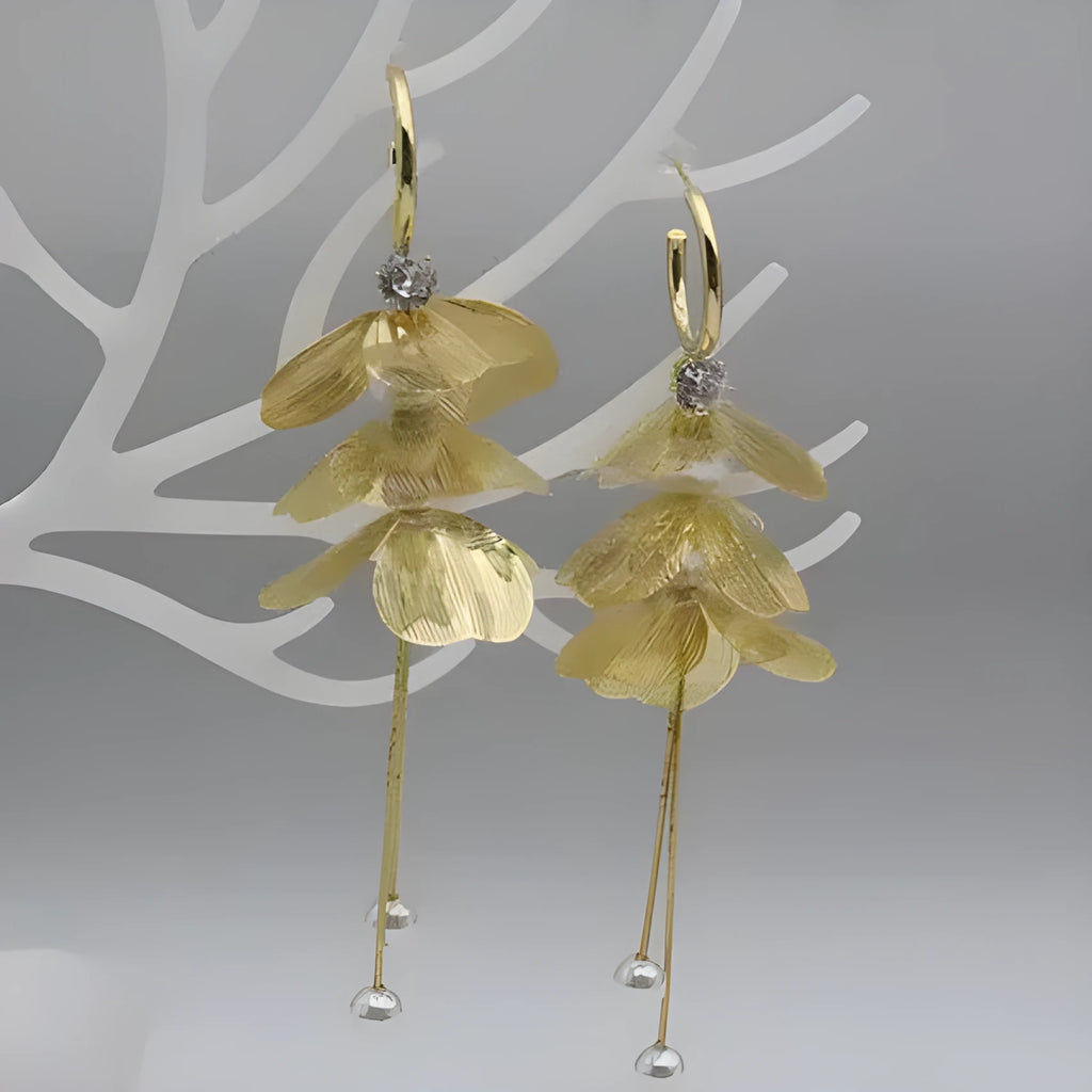 Gold floral petal pearl fringe drop earrings with electroplated alloy finish on neutral background