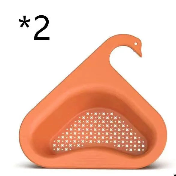 Yellow hanging swan drain basket made of plastic, fitted on a kitchen sink edge with space for vegetables and utensils