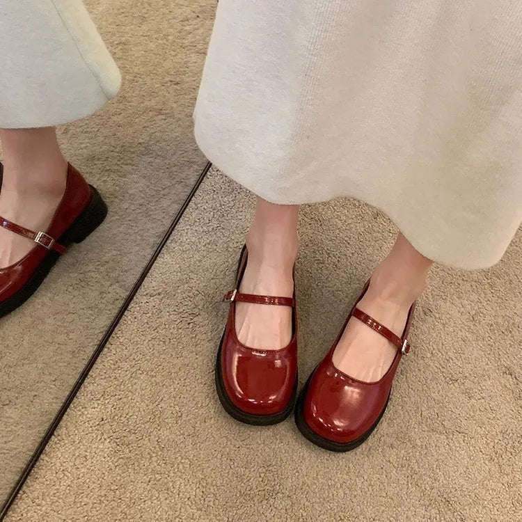 Women's solid colour flat shoes with round toe in red, black, and grey options