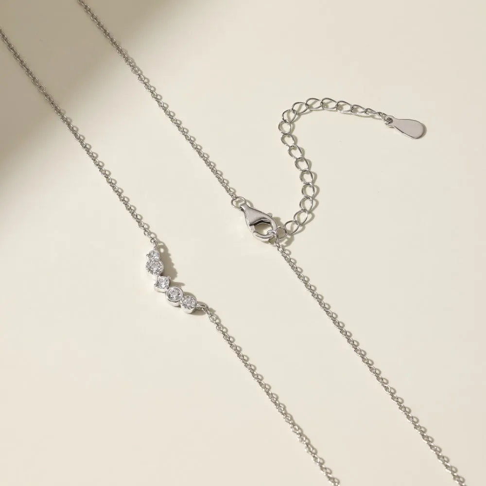 Geometric zircon pendant necklace in 925 silver with gold electroplate finish on display