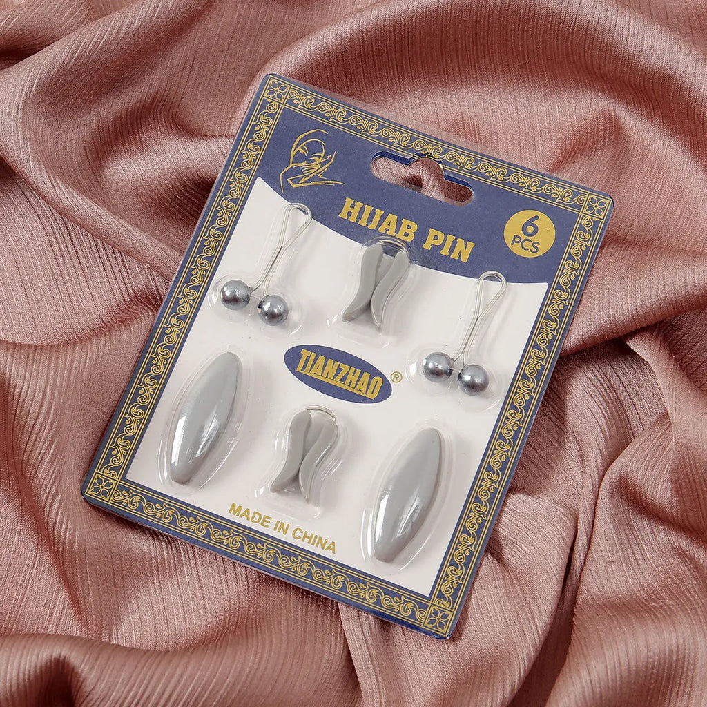 Plastic scarf clip with oval meander pattern and resin drip finish in five colours including black, gray, white, brown, and pink.