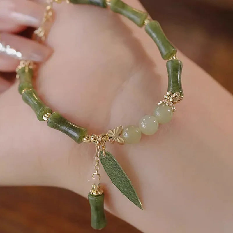 Chinese style glass bracelet with bamboo joint details in a red Lvzhu Duobao design.