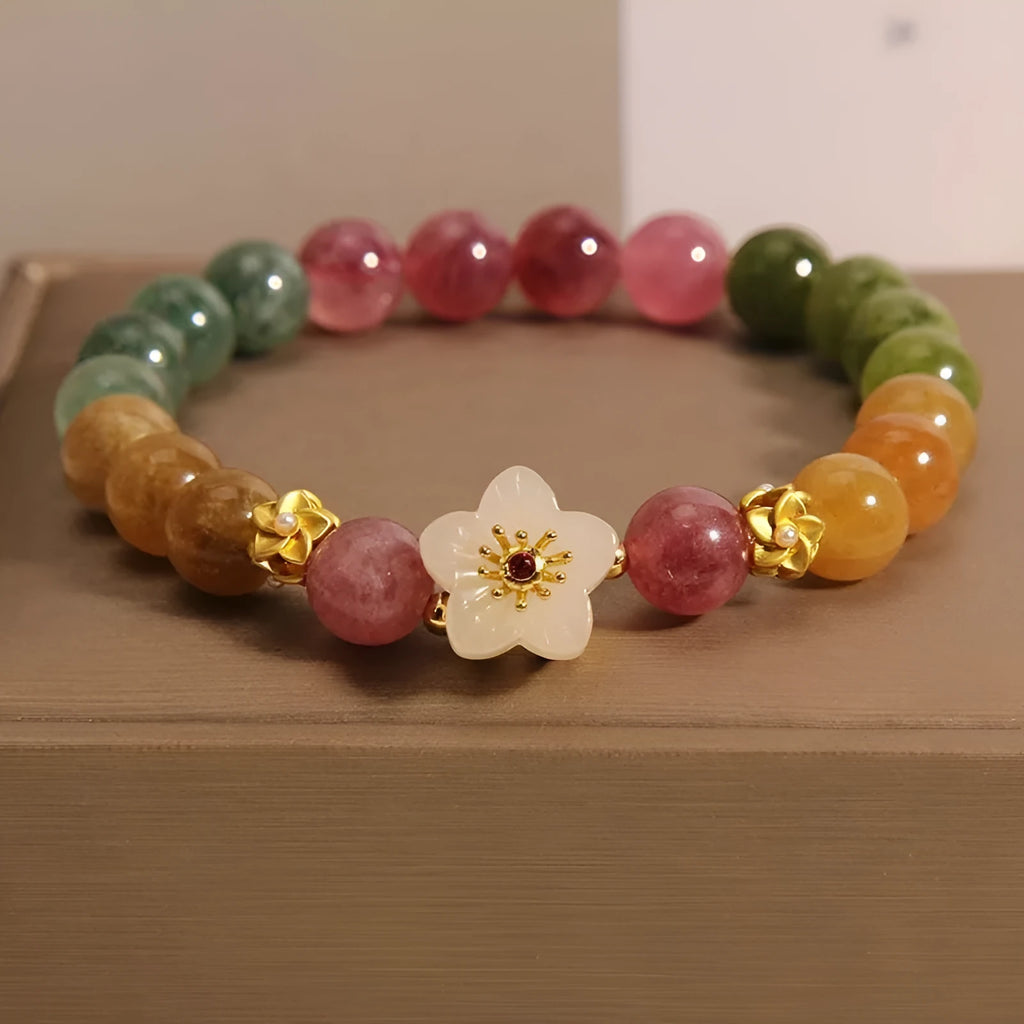 Natural colour tourmaline bracelet with floral and fu character charms on geometric electroplated chain
