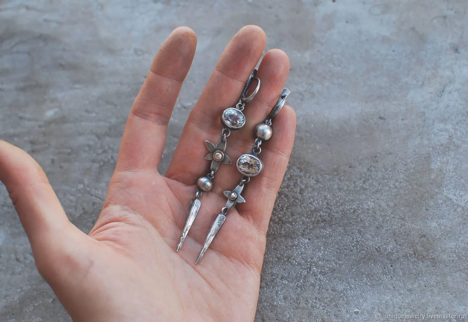 A pair of long geometric XINGX pendant earrings in antique silver with rhinestones.