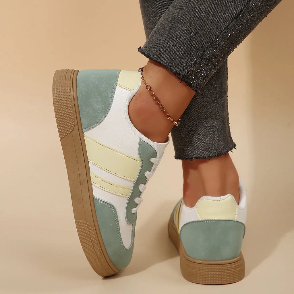 Green women's retro sports low-top shoes with cross straps and round toe on a rubber sole.