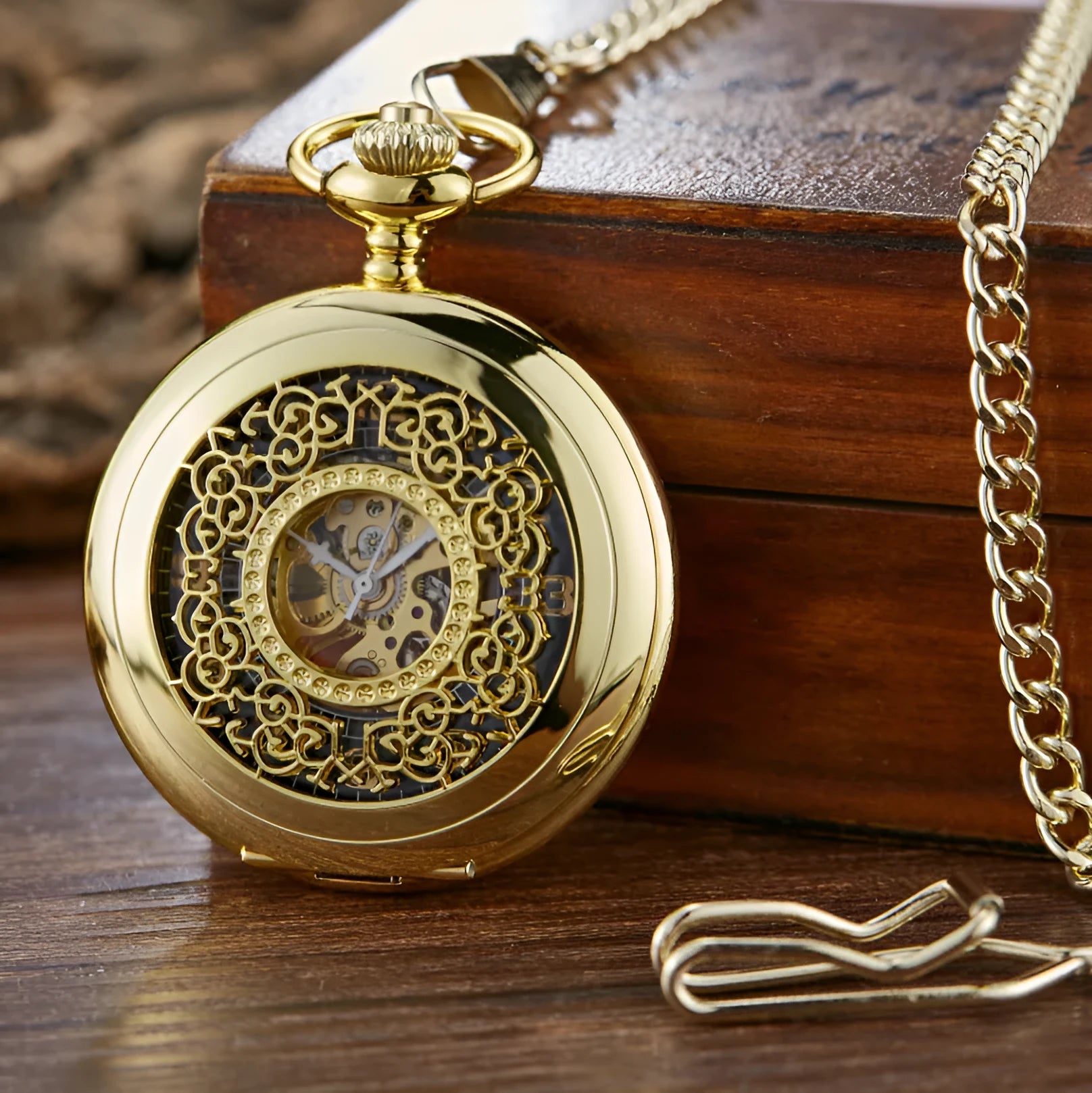 Retro hollow floral print mechanical pocket watch with transparent case back in gold colour.