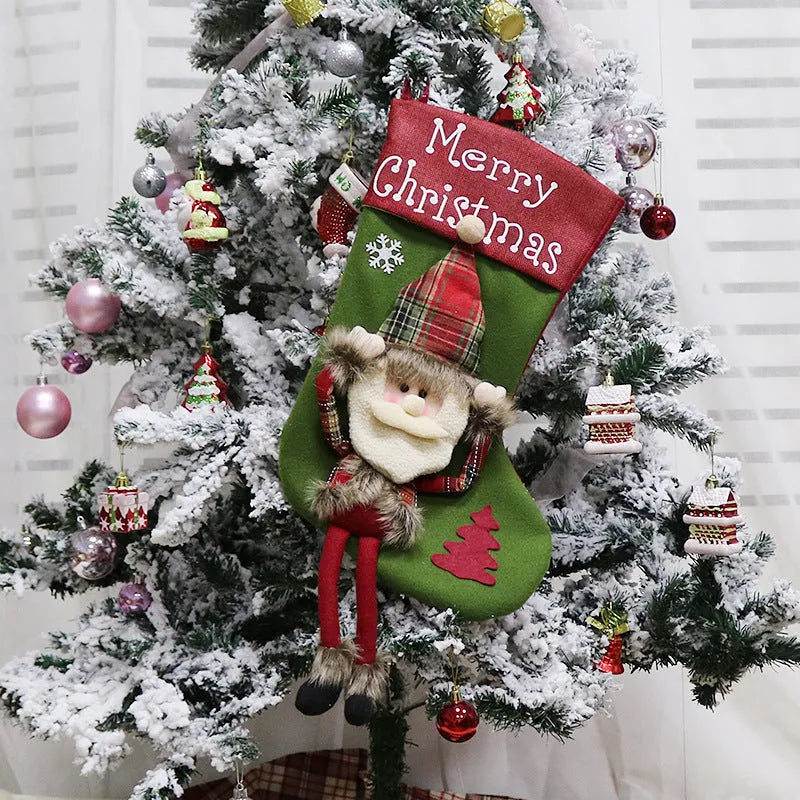 Set of three large 18-inch Christmas stockings with Santa, Snowman, and Reindeer 3D applique designs, hanging on a wooden mantel with festive decorations.