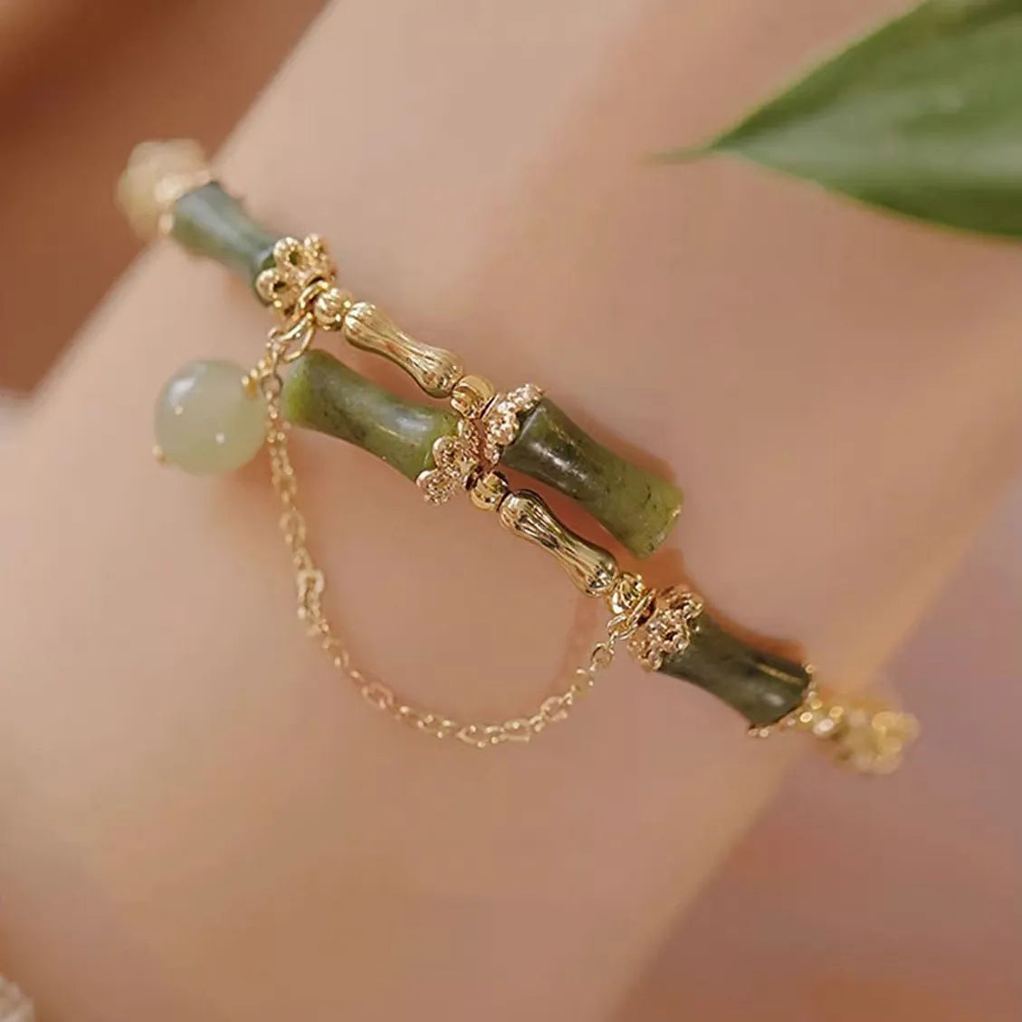 Women's bamboo beaded bracelet in plum wine colour with coloured glass and bamboo joint design.