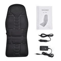 Black electric cervical massager with wireless remote on a table next to international power plugs.