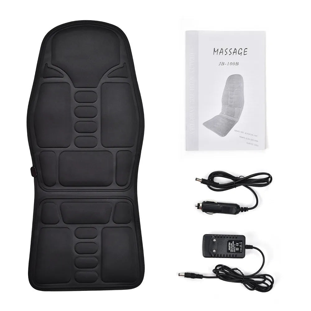 Black electric cervical massager with wireless remote on a table next to international power plugs.