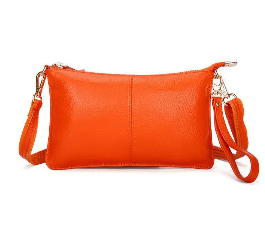 Structured cowhide lady slant bag in apricot colour with hand strap and shoulder strap, showing slim profile.