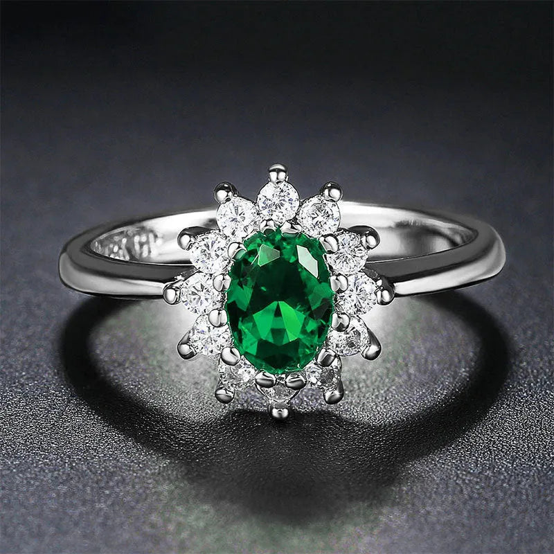 Copper women's ring with floral band and inlaid blue zirconium stone, shown on a finger.