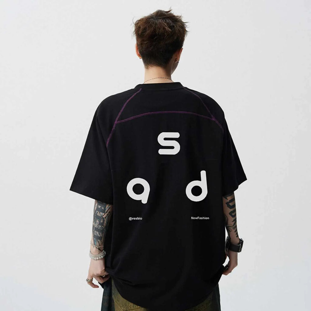 A loose-fitting black cotton t-shirt with letter print detail on the front, showing short sleeves and a round neck.