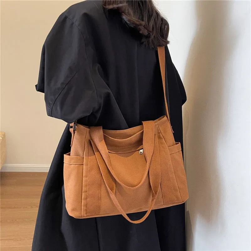 Polyester shoulder bag in solid colour with sandwich pocket and phone compartment