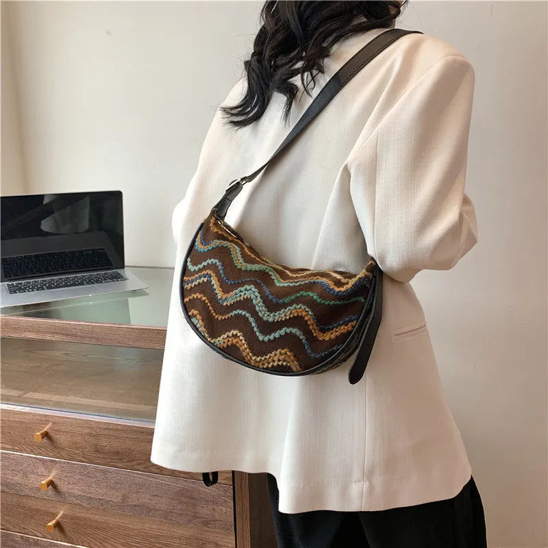 Straw woven crossbody bag showing woven texture and interior phone compartment