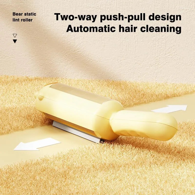 Blue reusable pet hair remover roller with self-cleaning base on a grey sofa.