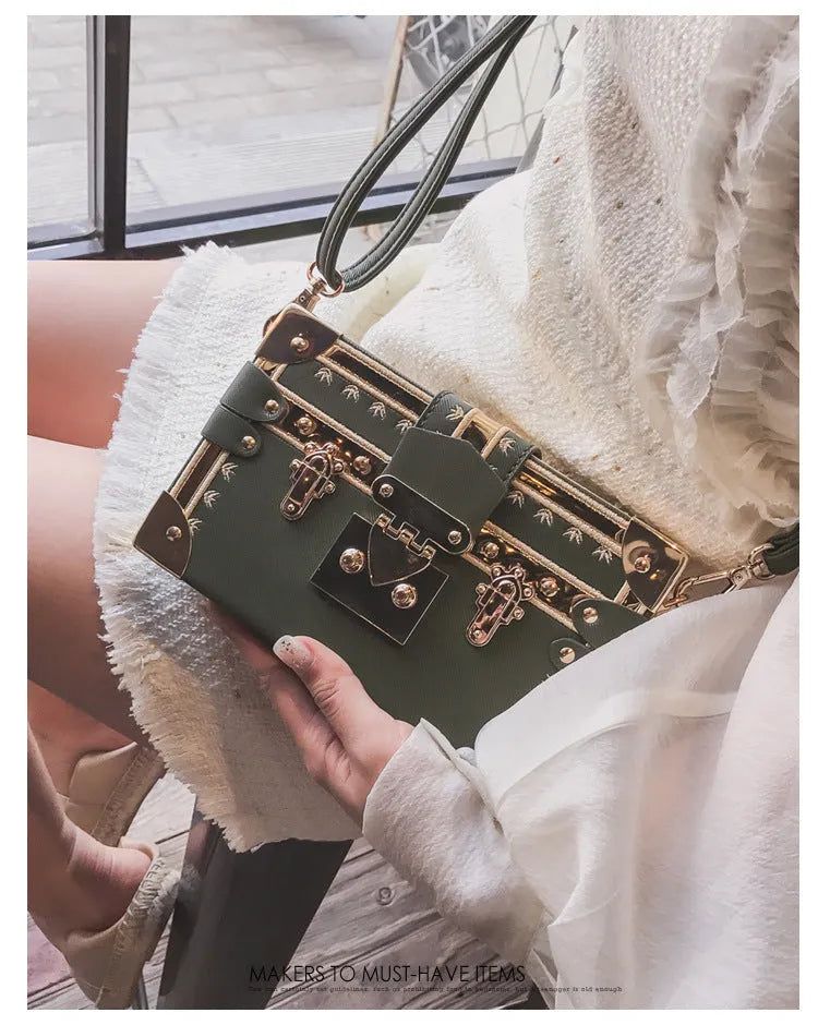Women's hard PU shoulder bag with flap closure and crossbody strap in black colour with rivet decoration