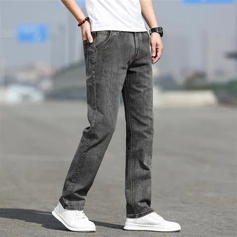 Men's smoky gray straight tube jeans with low waist and zipper fly closure