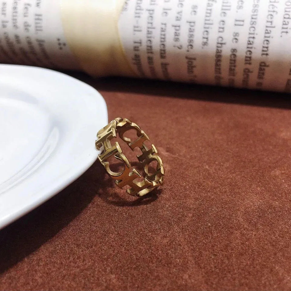 Gold titanium steel hollowed cut letter ring in unisex geometric Korean style, sizes 6-9