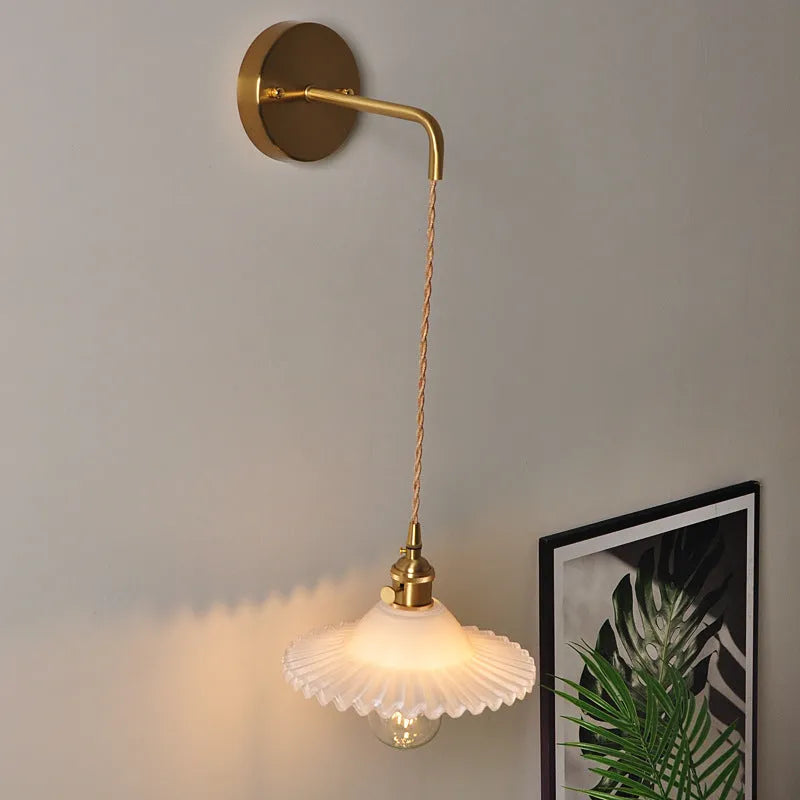 Retro copper lotus wall lamp with glass shade in choice of six colours, suspended from a wall