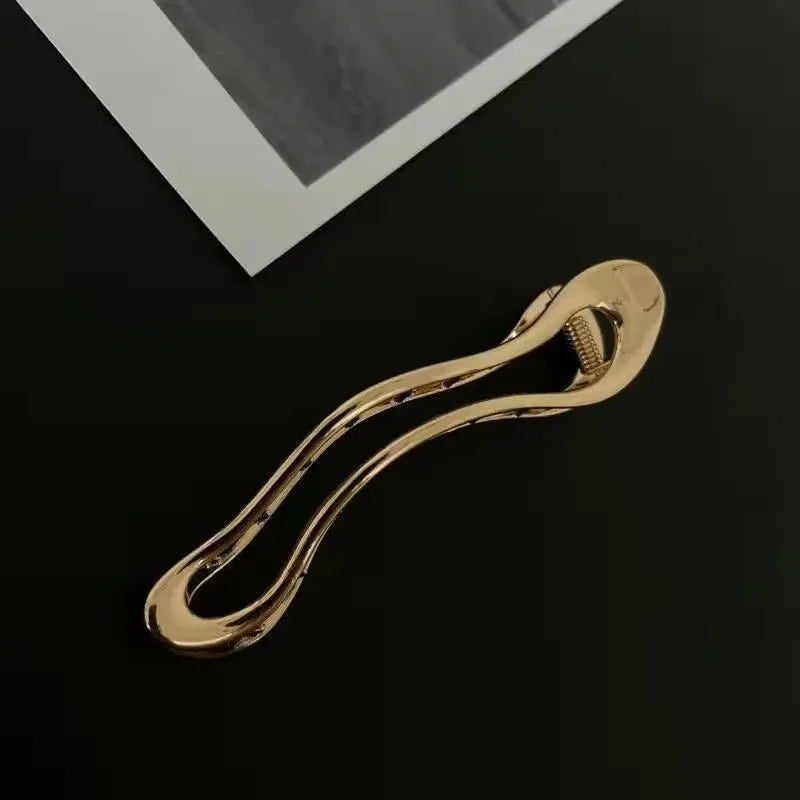 Gold and silver zinc alloy hair clips in arc, square, and triangle geometric shapes