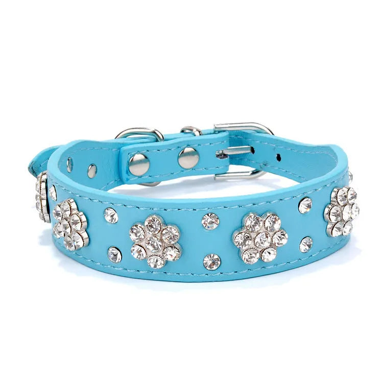 Decorative black PU leather dog collar with studded rhinestone flower pattern and silver metal D-ring.
