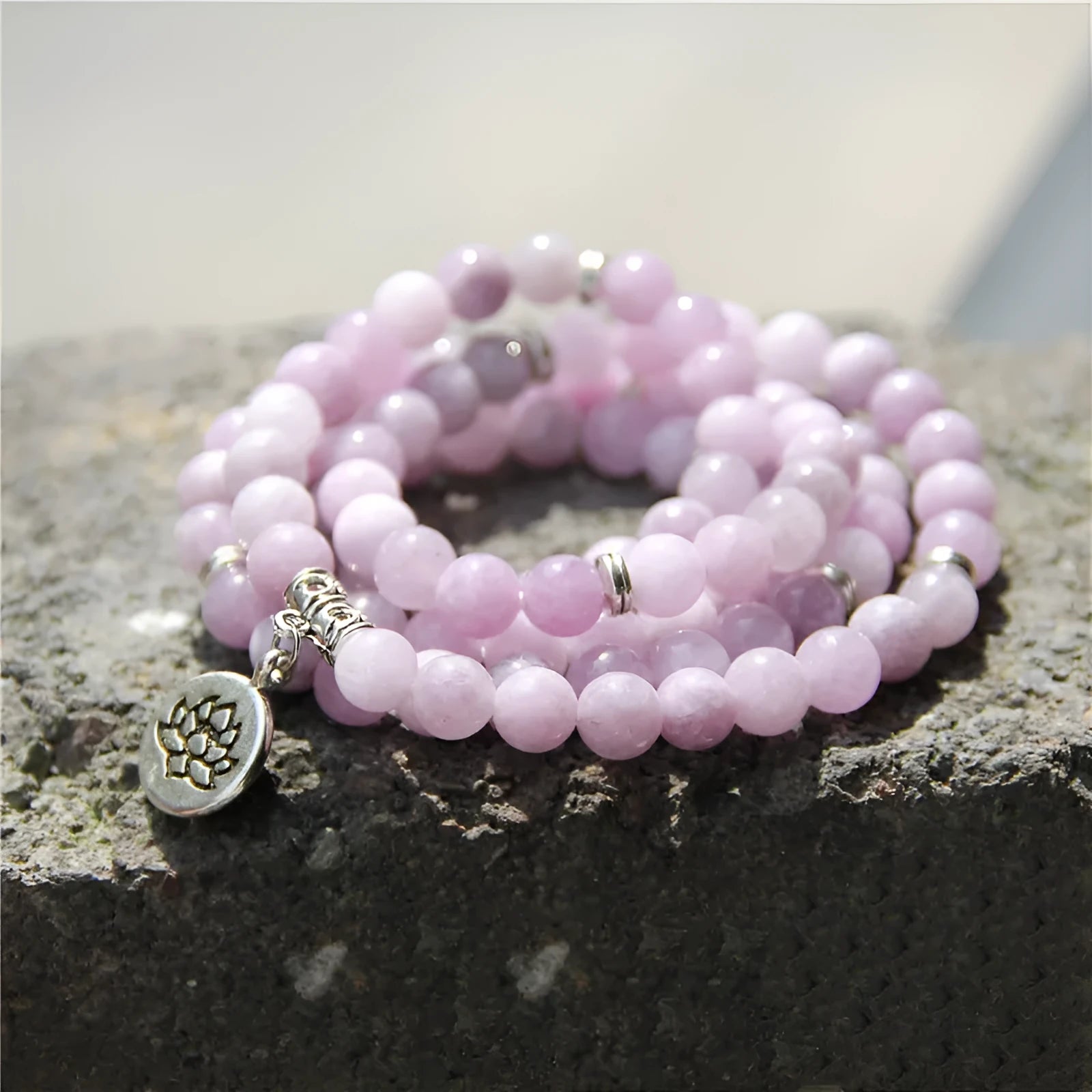 Women's bracelet with natural stone lotus pendant in geometric design showing eight colour variations