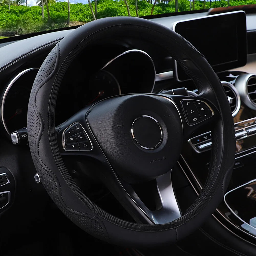 Black elastic steering wheel cover with corrugated texture, stretched to show fit on a 37-38cm wheel.