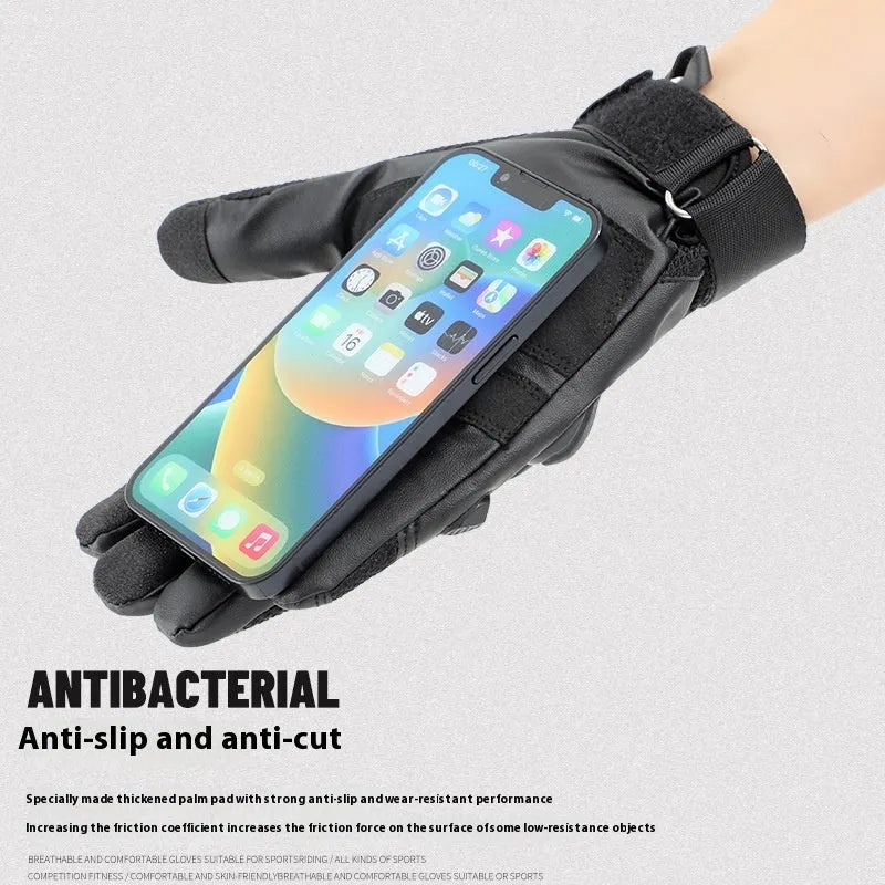 Men's black full finger tactical gloves with touch screen fingertips on a hand holding a phone.