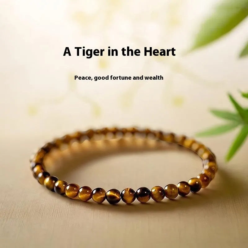 Tigereye stone bracelet with geometric Chinese design showing round elements and bead detailing