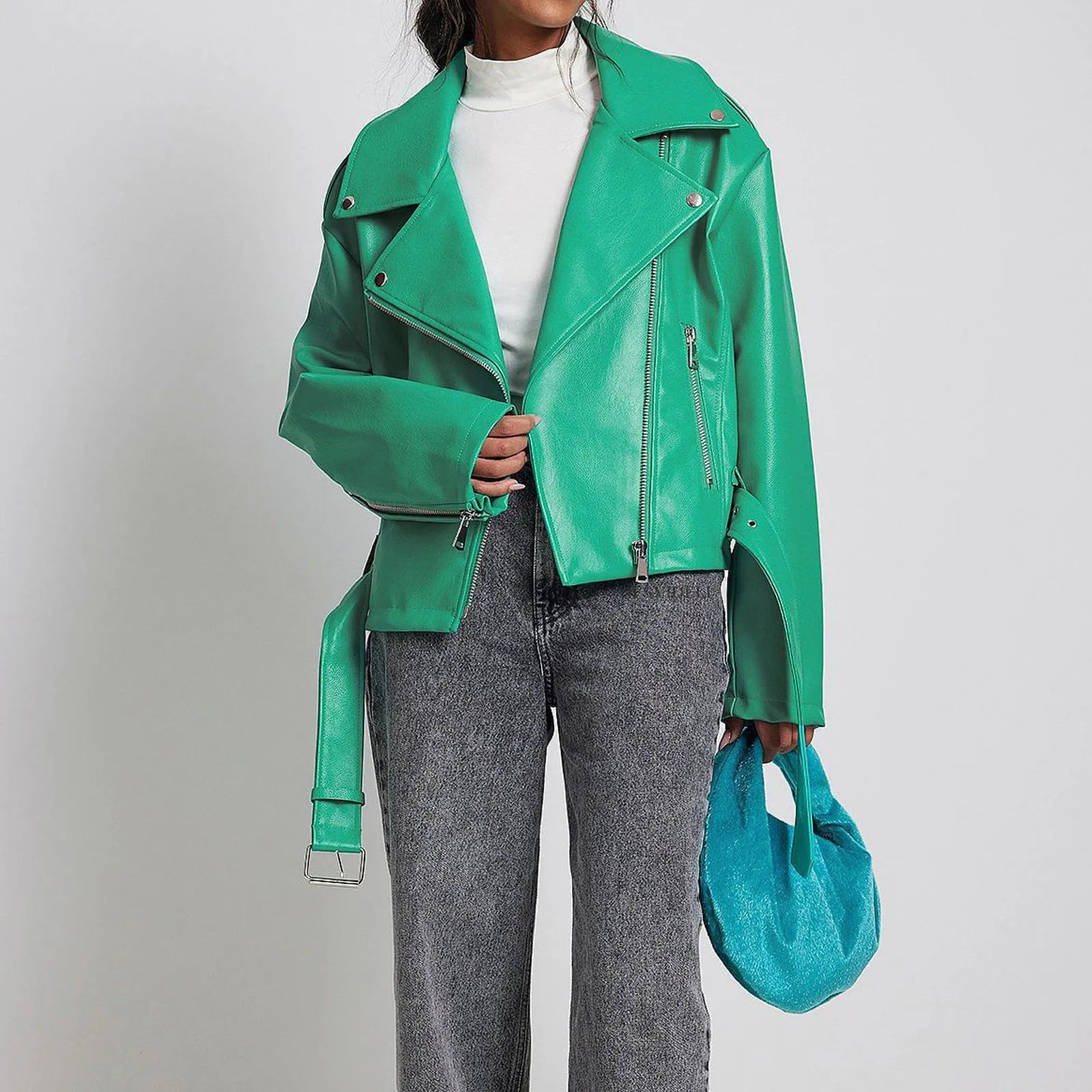 A black punk-style jacket with a lapel, short belt, and Peter Pan collar on a hanger.