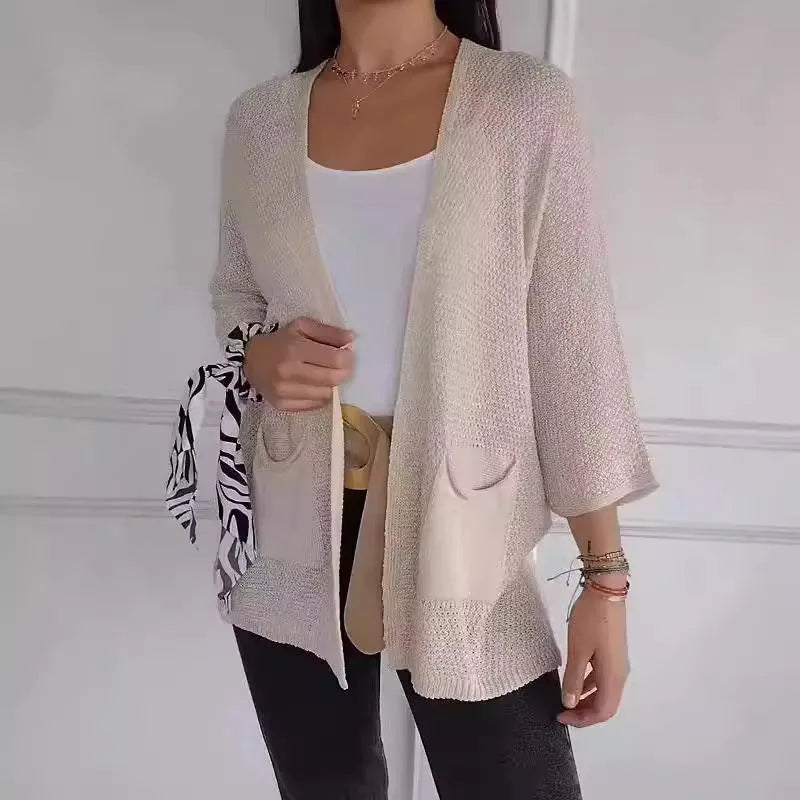 Women's army green waffle weave cardigan coat with nine-quarter length sleeves and pockets.