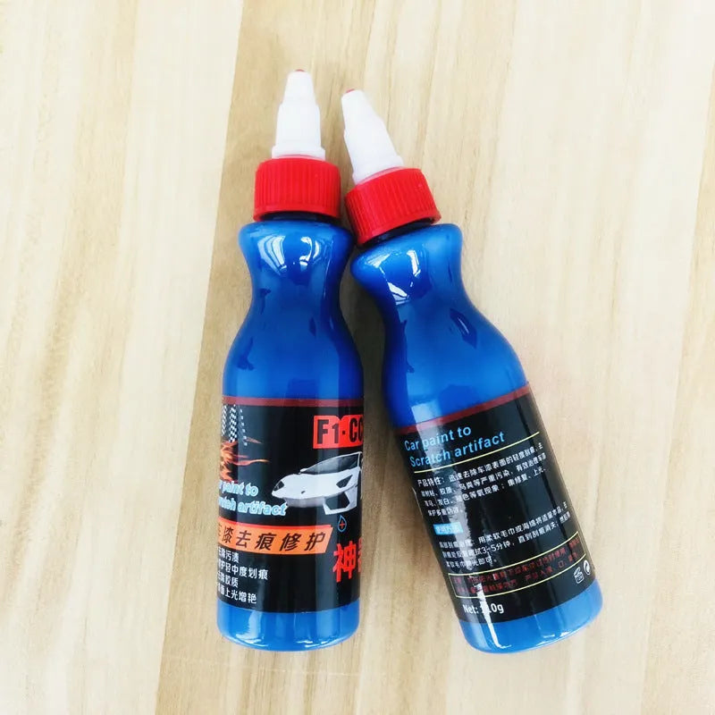 Small blue container of car scratch repair agent with sponge applicator for vehicle paint touch-ups