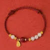Women's adjustable 925 silver bracelet with Hetian jade and cinnabar red rope design on wrist