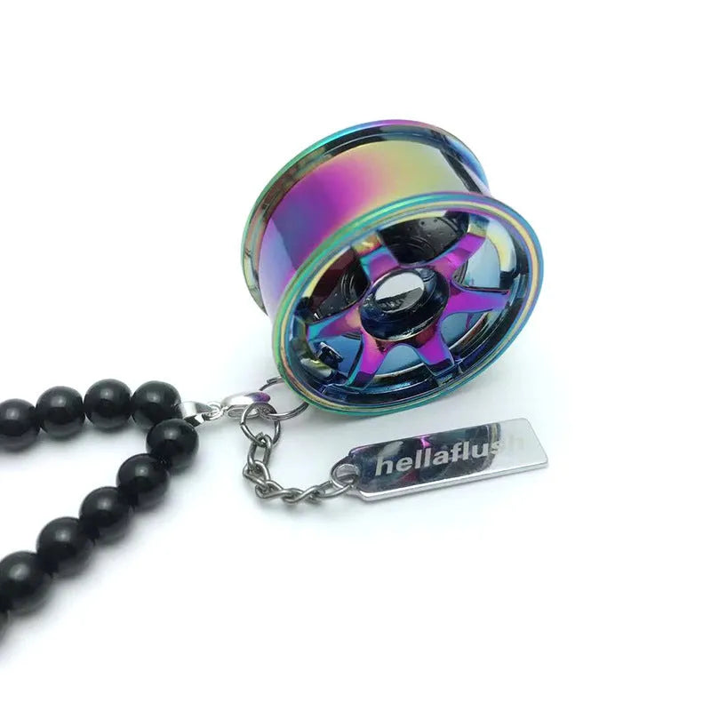 Stainless steel car tyre ornament with crystal glass bead chain hanging from a rearview mirror