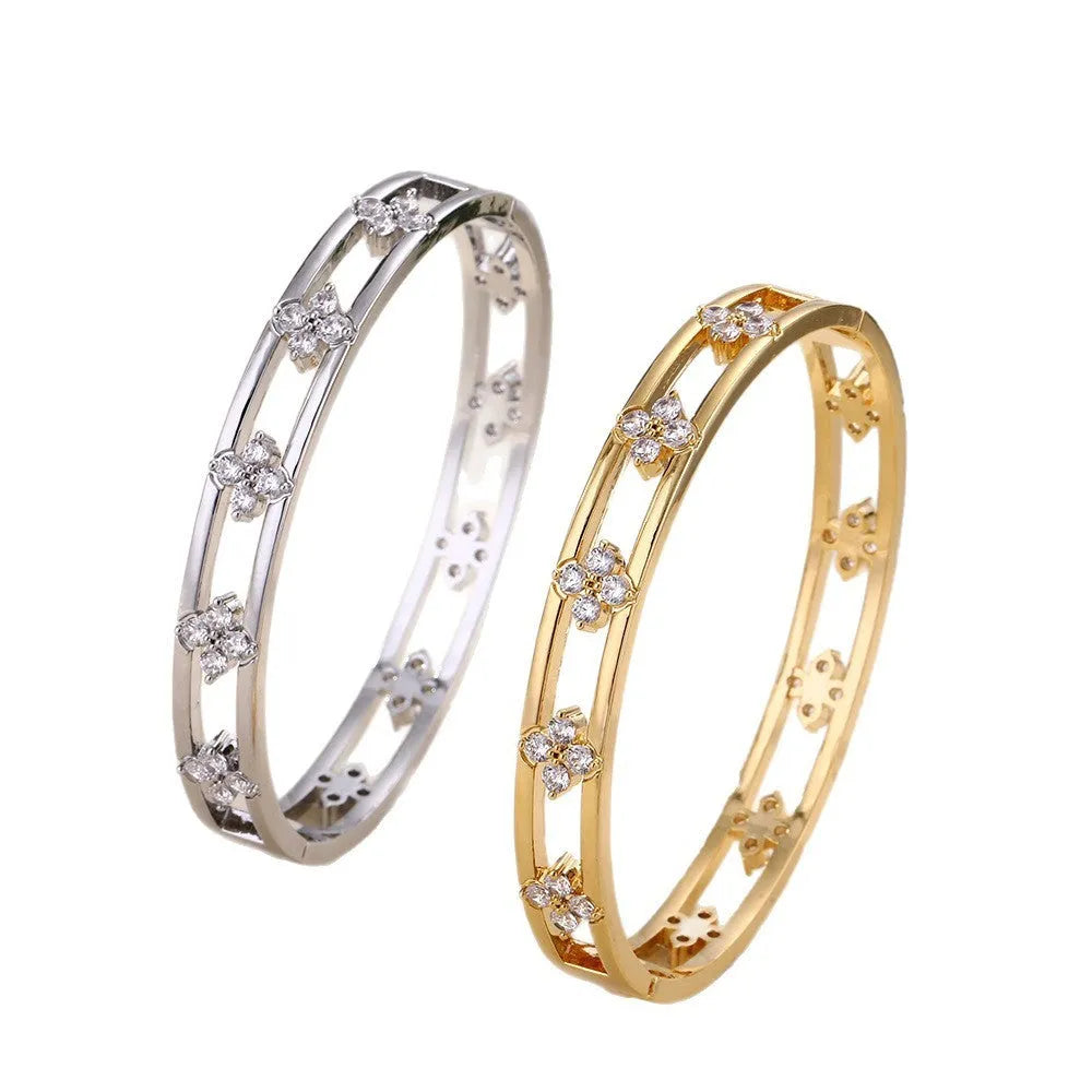 Gold or silver hollow women's bracelet with a four-leaf clover charm containing a white zircon stone.