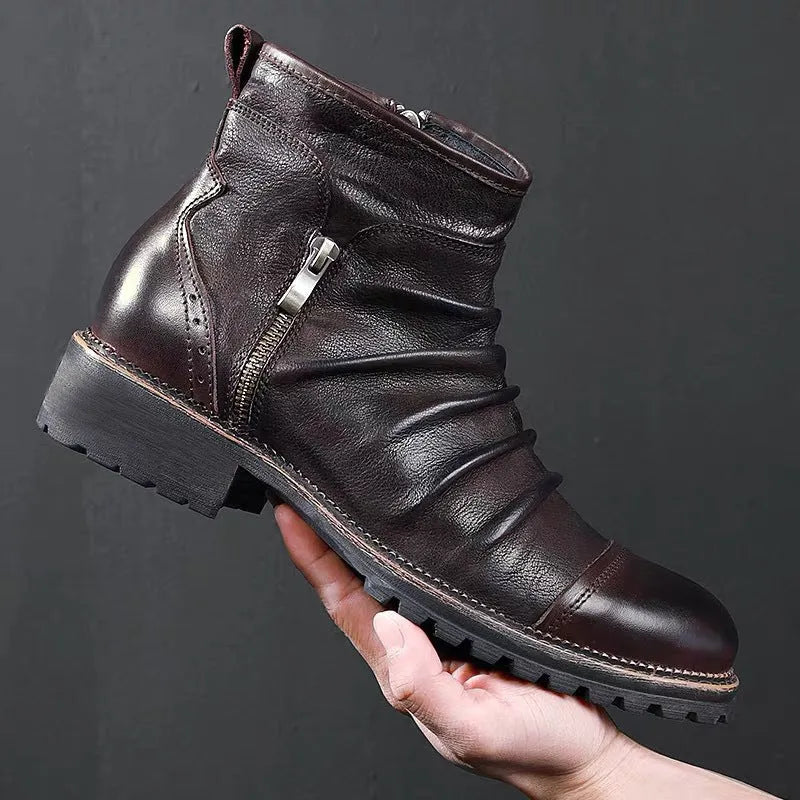 Men's black side-zip cowboy boots with a round toe and horseshoe heel on a wooden floor.