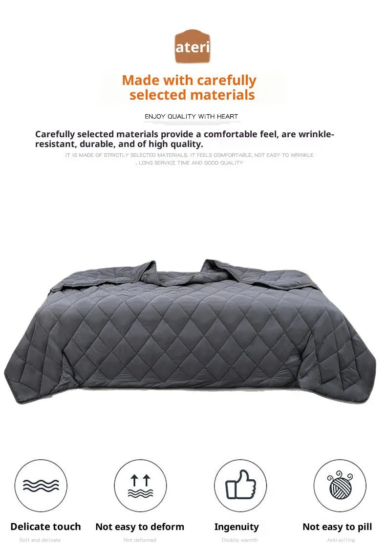 Polyester gravity blanket in solid light grey on bed, 152x203cm size, 12 lb weight option