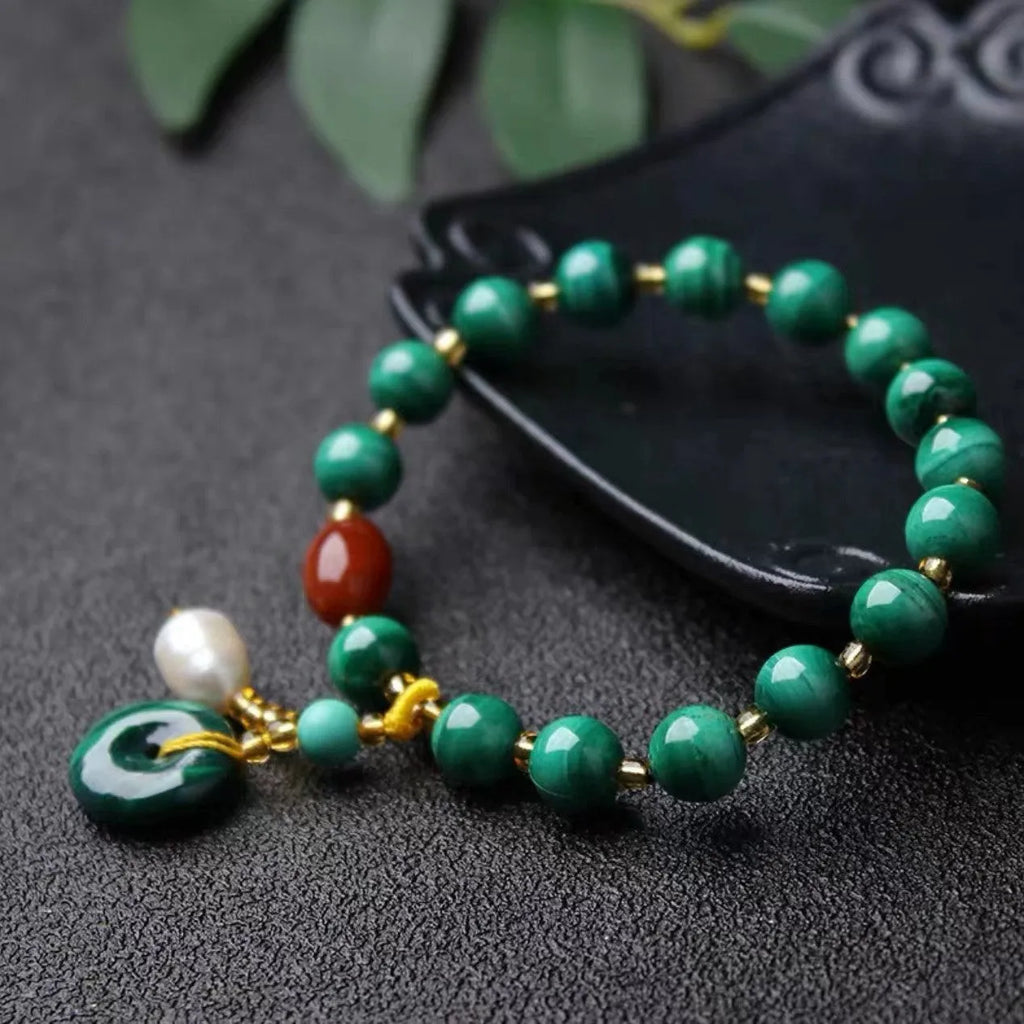 Natural malachite bracelet with southern red agate barrel beads showing green and red stone details