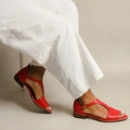 Red women's plus size sandals with a square buckle and herringbone toe pattern on a low-top casual design.