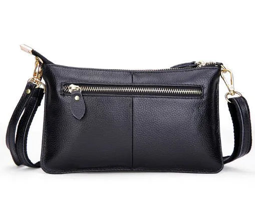 Structured cowhide lady slant bag in apricot colour with hand strap and shoulder strap, showing slim profile.