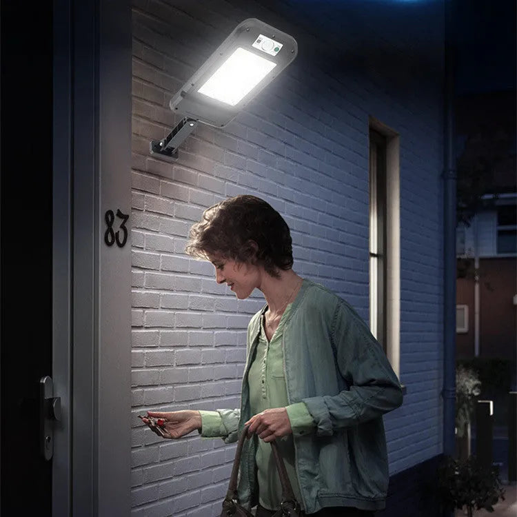 Solar wall light with 160COB LED lamps and motion sensor mounted on outdoor wall