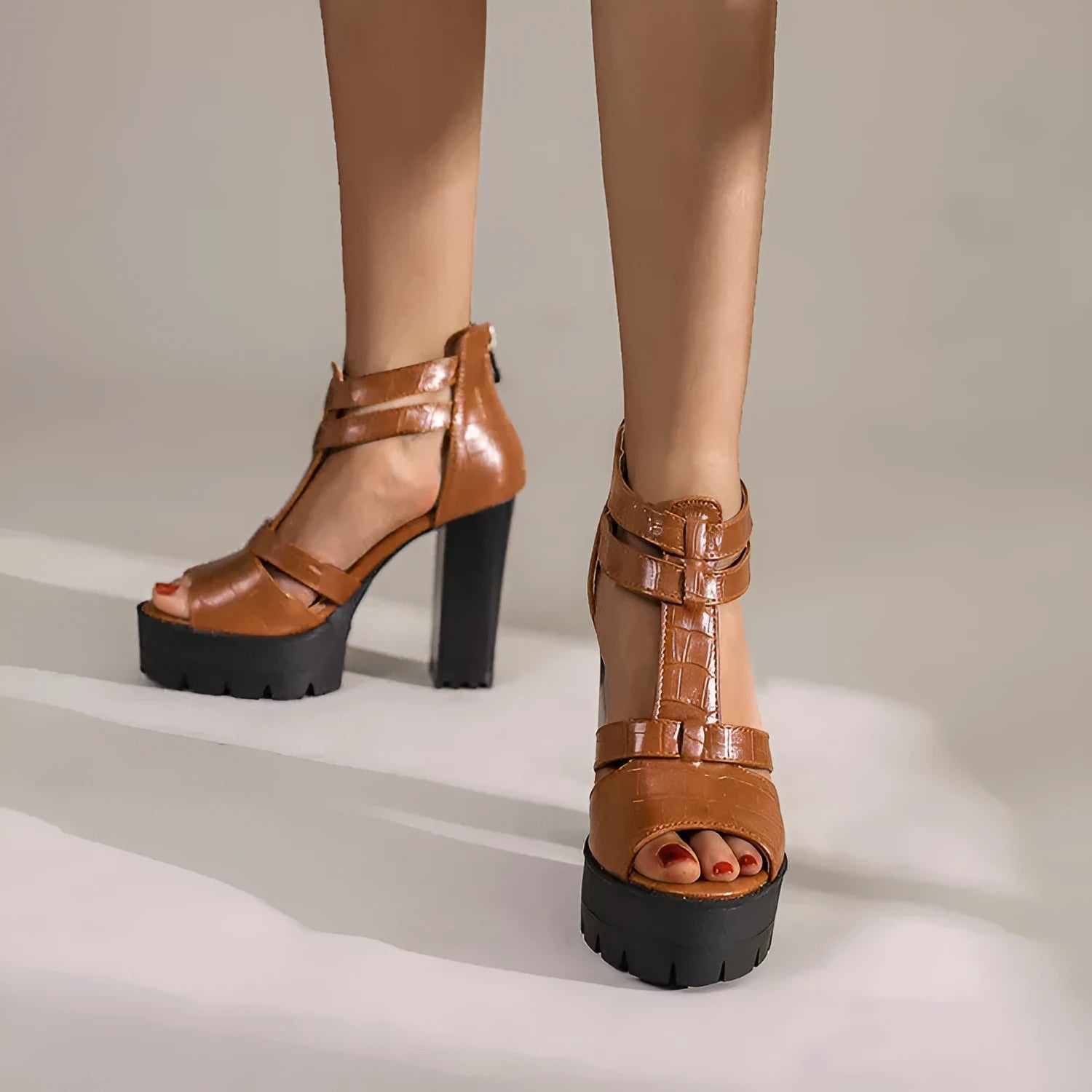 Women's black platform high heel sandals with a round toe and a back zipper fastening.