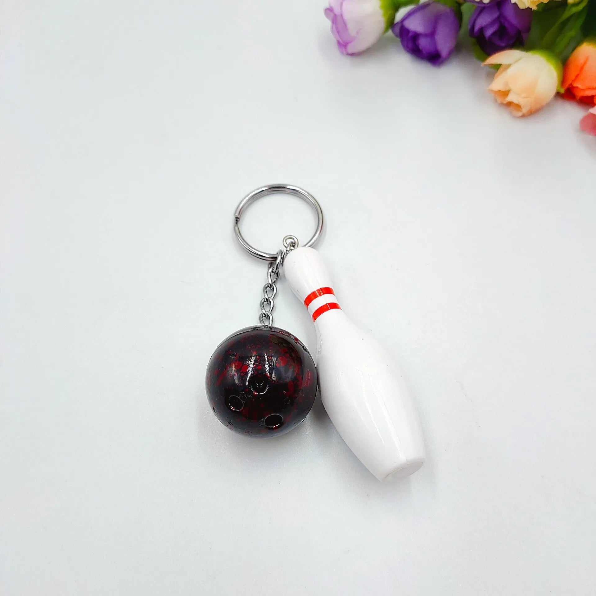 Mini bowling pin keychain pendant in four colour options with key ring attachment