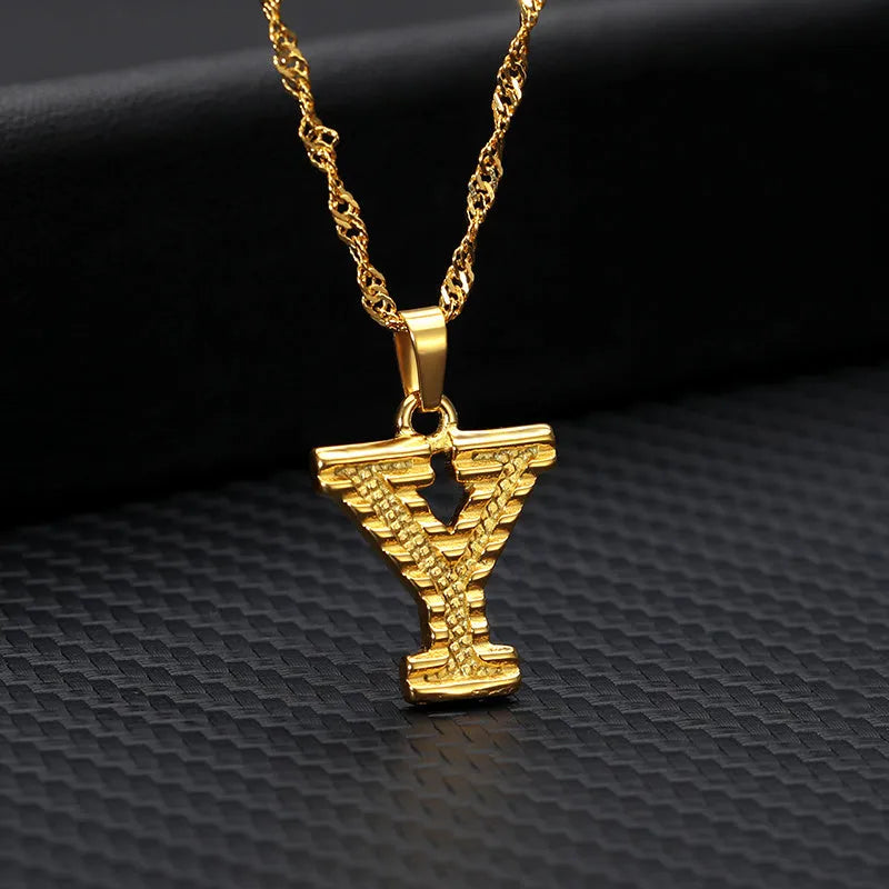 Gold-plated alloy initial pendant necklace with 42cm chain on white background