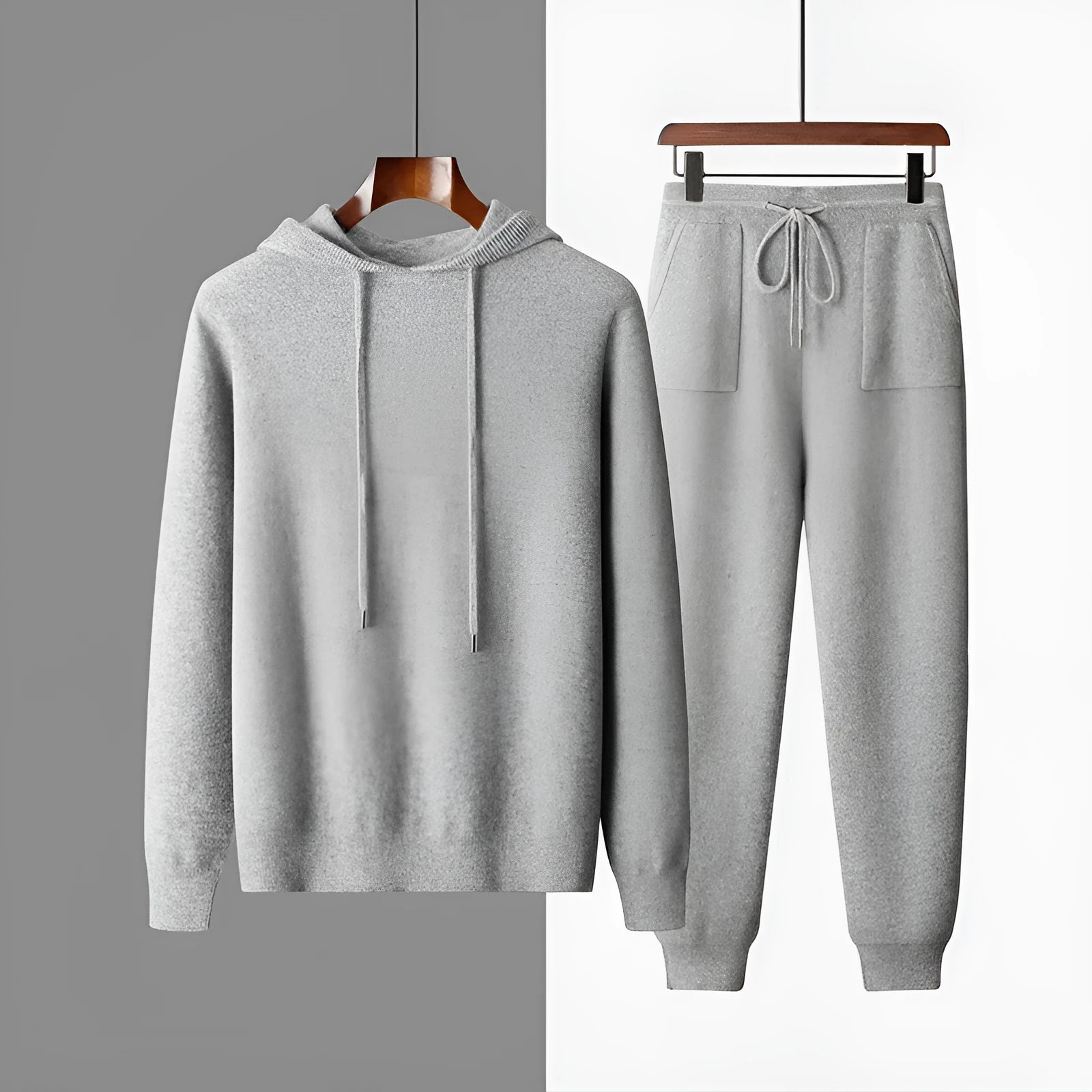 Men's light grey cashmere hooded sweatshirt and matching long pants set laid flat.