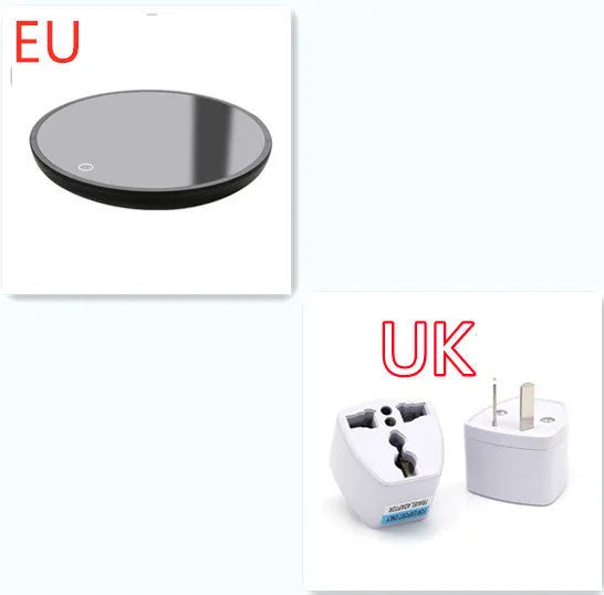 Black circular coffee mug warmer with a tempered glass surface on a desk.