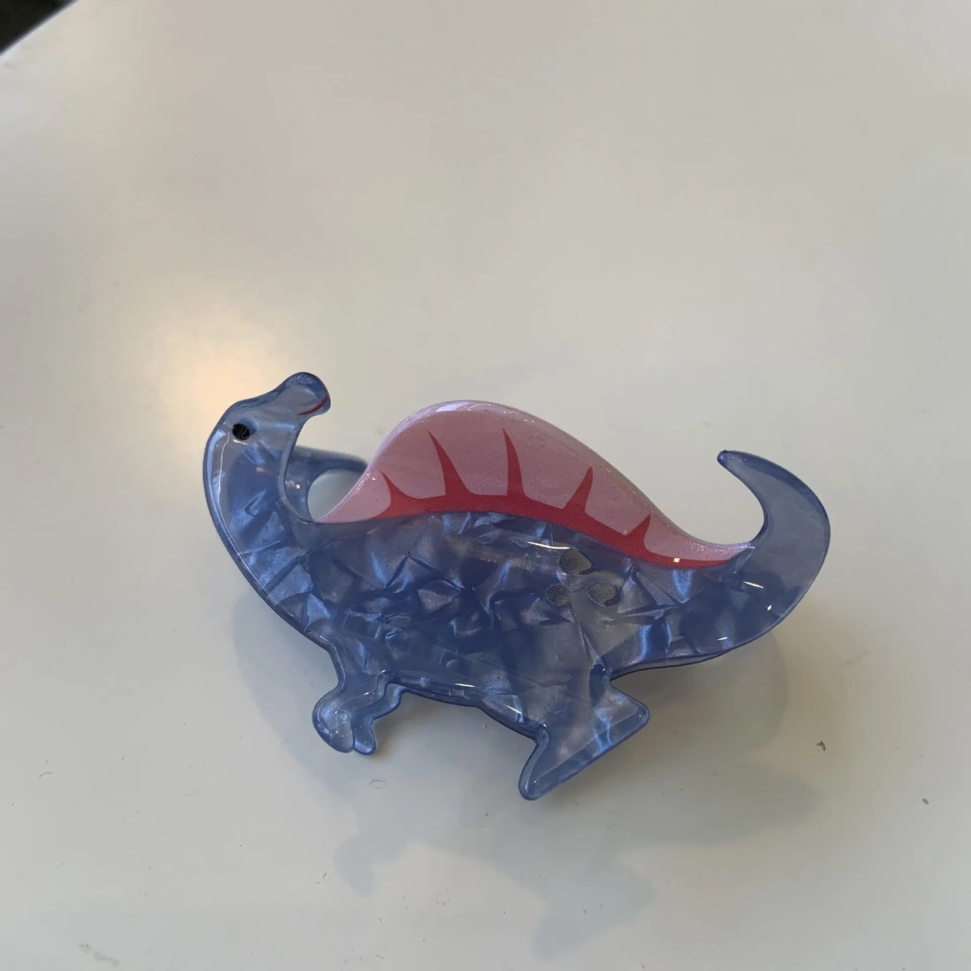 Dinosaur-themed acrylic jaw hair clip showing grip design with miniature dinosaur decoration