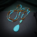 Turquoise water drop shaped pendant necklace with geometric design and ball bead chain