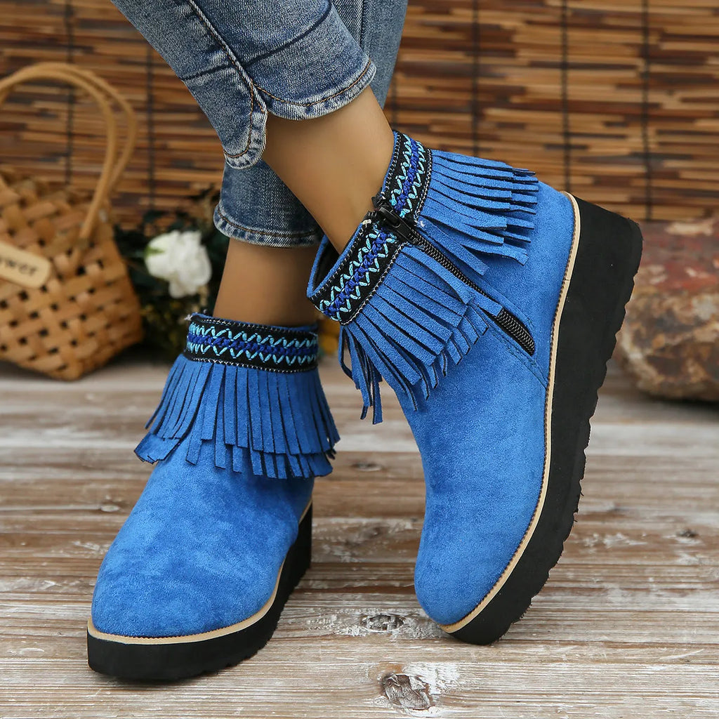 Women's dark brown suede wedge bootie with side zip, tassel detail, and thick rubber sole